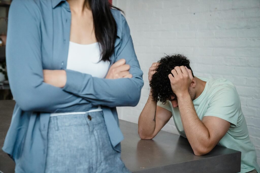 A couple experiencing relationship stress and conflict in an indoor setting, illustrating discord and tension.